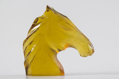 Golden horse head sculptures in glass and ceramic